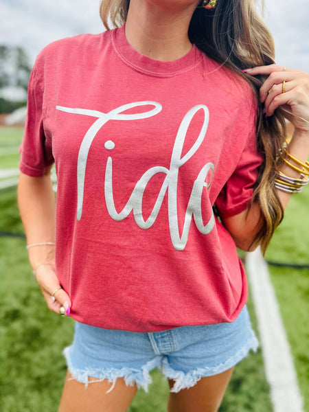 Person wearing a red 'Tide' t-shirt outdoors