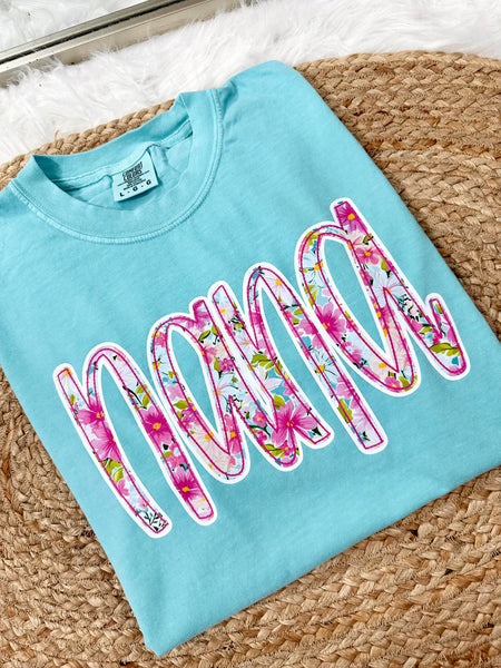 Chalky Mint Light blue tee sweatshirt with floral graphic 'nana' dtf print text on a textured surface